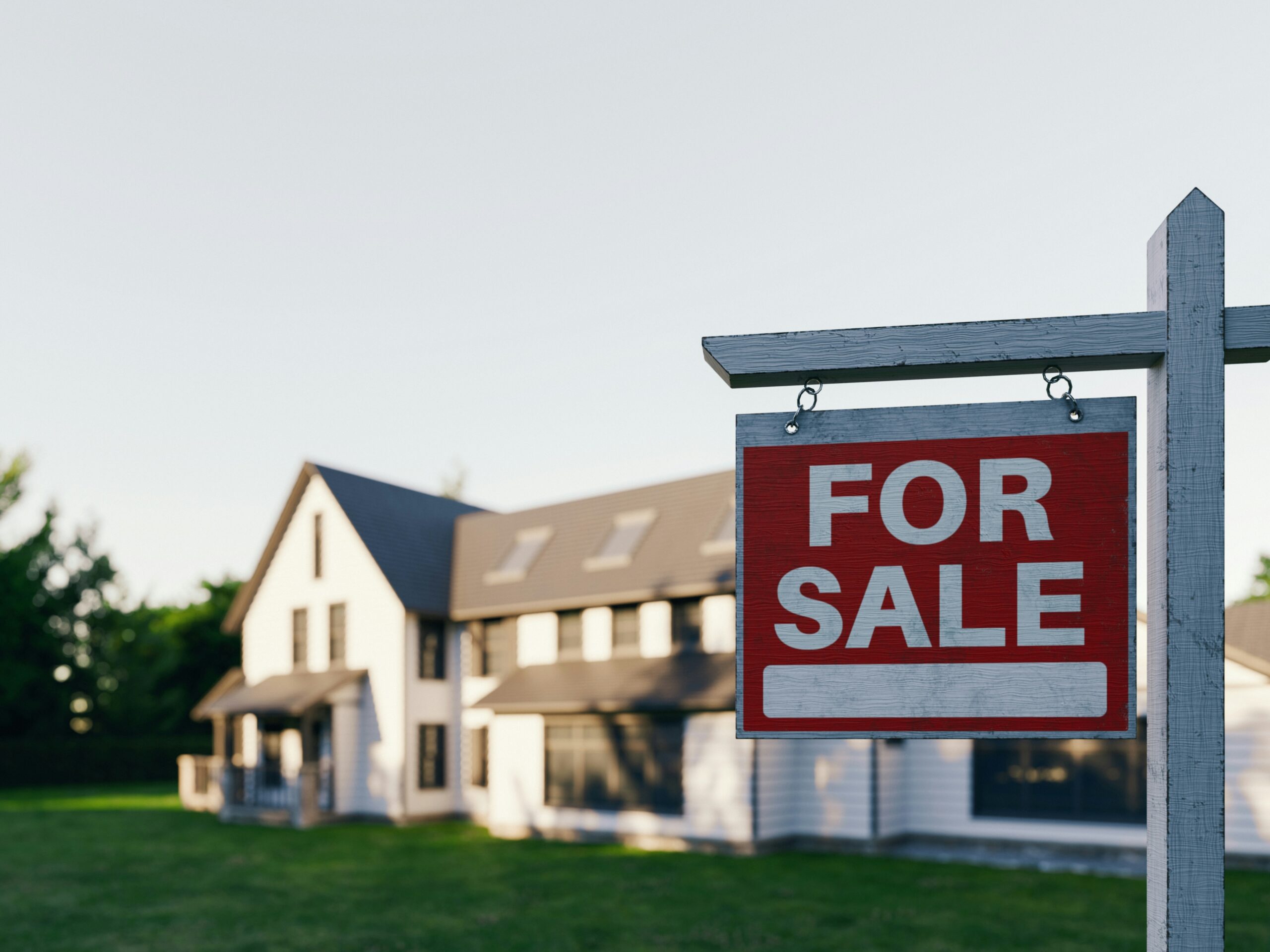 Spring street view of a Central Arkansas neighborhood with a for-sale sign in front of a home
