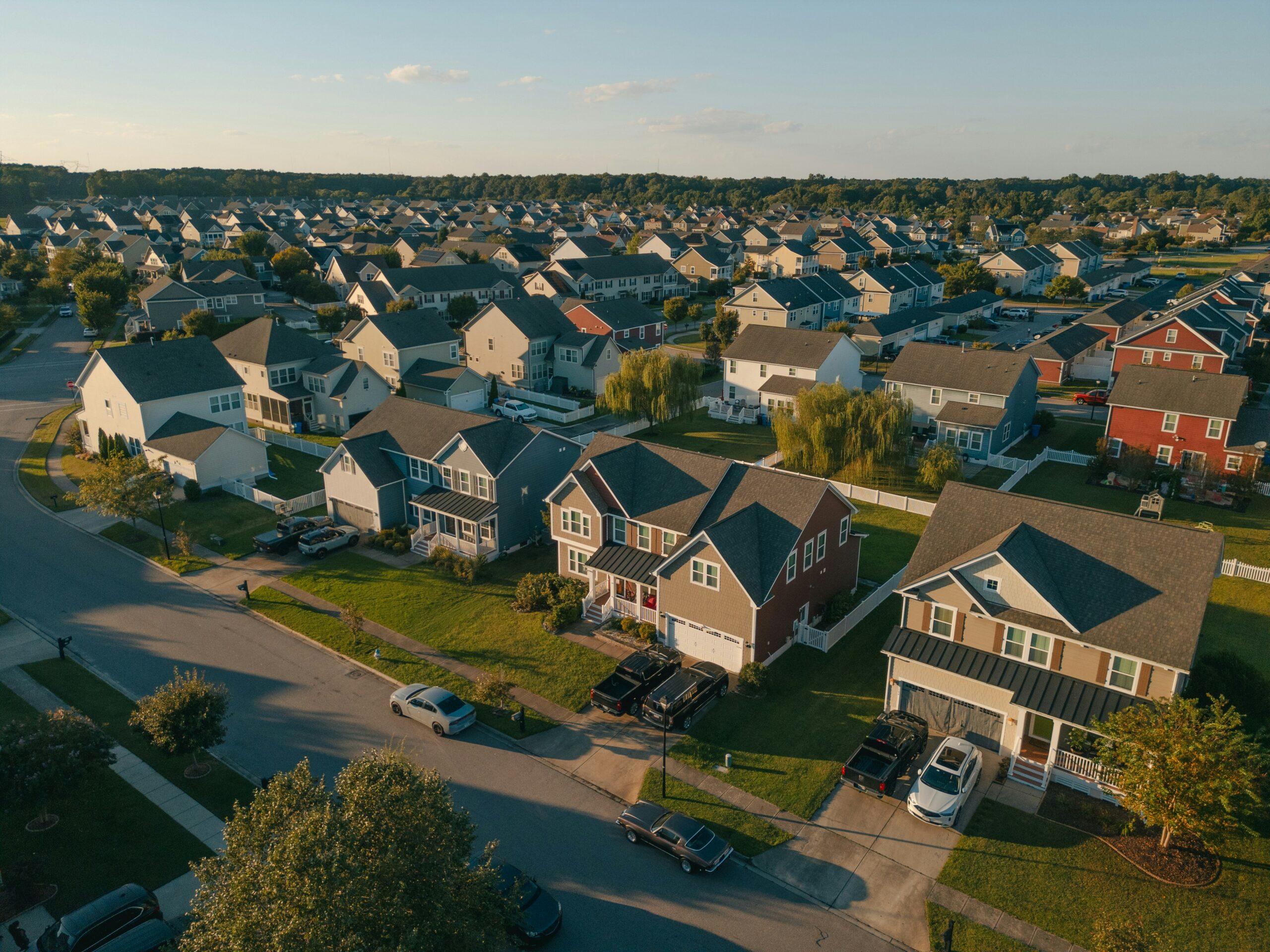 Aerial view of a Central Arkansas neighborhood with tree-lined streets and family homes